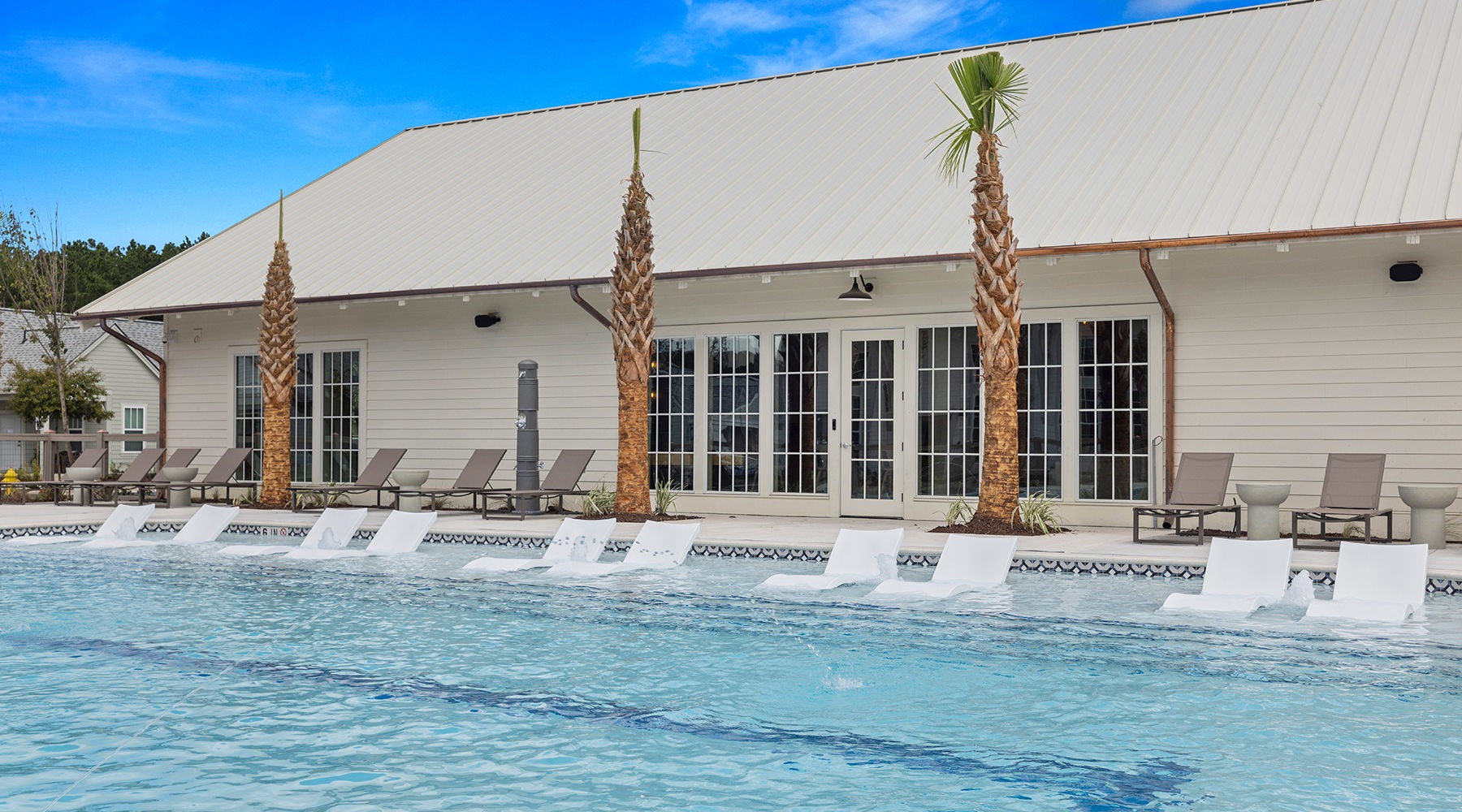 pool with palm trees and clubhouse