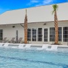 pool with palm trees and clubhouse